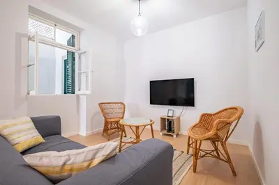 a living room with a couch and chairs and a tv at CASA DA ROCHINHA in Funchal