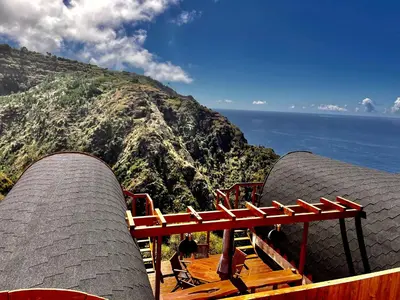 a view of the ocean and a mountain at The tiny black bird in Fajã da Ovelha