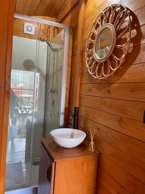 a bathroom with a sink and a mirror on a wall at The tiny black bird in Fajã da Ovelha