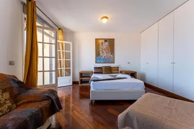 a living room with a bed and a couch at FLH Funchal Artistic Apartment with Balcony in Funchal