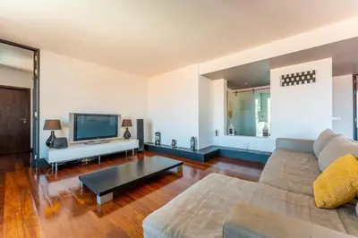 a living room with a couch and a tv at FLH Funchal Artistic Apartment with Balcony in Funchal