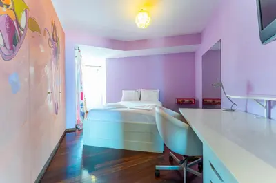 a bedroom with a bed and a desk with a chair at FLH Funchal Artistic Apartment with Balcony in Funchal