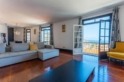 a living room with a couch and a table at FLH Funchal Artistic Apartment with Balcony in Funchal