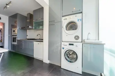 a kitchen with a washer and dryer in it at FLH Funchal Artistic Apartment with Balcony in Funchal