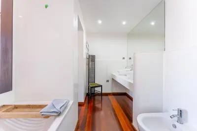 a bathroom with a sink and a bath tub at FLH Funchal Artistic Apartment with Balcony in Funchal