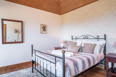 two beds in a room with blue walls at Rainbow Cottage by Homie in Ponta do Pargo