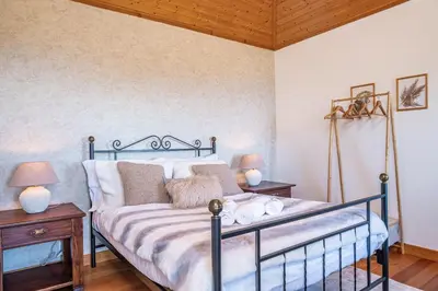 two beds in a room with blue walls at Rainbow Cottage by Homie in Ponta do Pargo