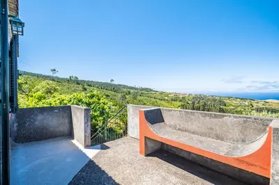 a bedroom with a large bed and a wooden ceiling at Rainbow Cottage by Homie in Ponta do Pargo
