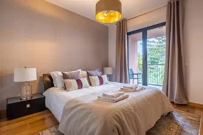 a bedroom with a large bed with towels on it at Living Funchal by Homie in Funchal