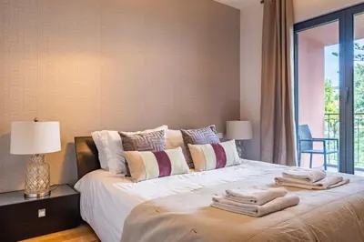 a bedroom with a white bed with towels on it at Living Funchal by Homie in Funchal