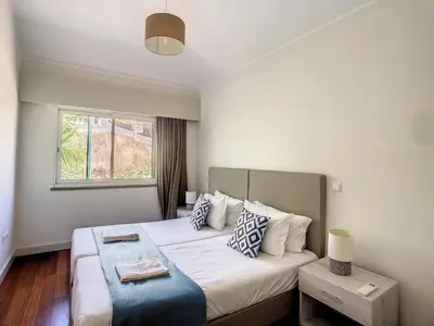 a hotel room with a bed with a window at Villa Miradoura by LovelyStay in Arco da Calheta