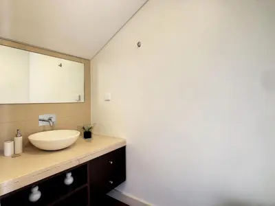 a bathroom with a sink and a mirror at Villa Miradoura by LovelyStay in Arco da Calheta