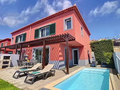 a house with a swimming pool in front of a house at Villa Miradoura by LovelyStay in Arco da Calheta