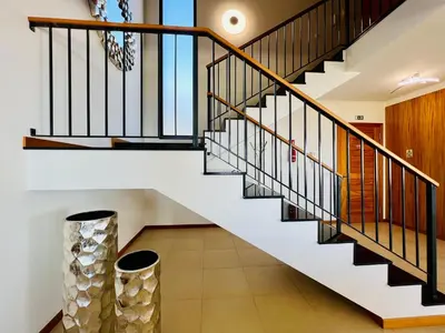 a staircase with black and white railings and a vase at Villa Carpe Diem by Your Madeira Rentals in Estreito da Calheta