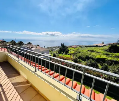 a balcony with orange seats and a view of the ocean at Villa Carpe Diem by Your Madeira Rentals in Estreito da Calheta