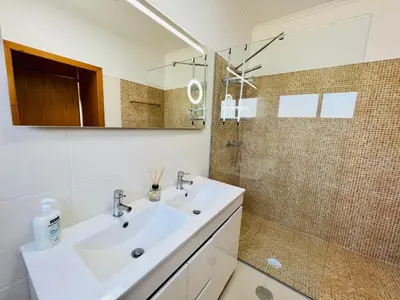 a white bathroom with a sink and a shower at Villa Carpe Diem by Your Madeira Rentals in Estreito da Calheta