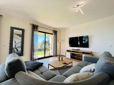 a living room with a couch and a tv at Villa Carpe Diem by Your Madeira Rentals in Estreito da Calheta