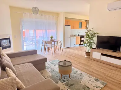 a living room with a couch and a flat screen tv at Casa Kiko in Burgau