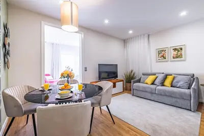 a living room with a table and chairs and a couch at Urban Paradise by Homie in Funchal