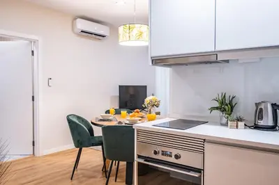 a kitchen with a table and chairs in a room at Urban Paradise by Homie in Funchal