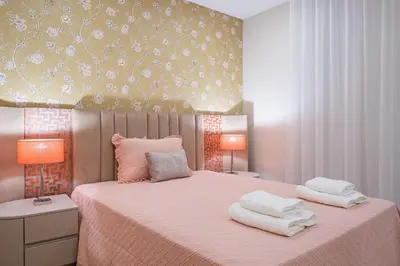 a bedroom with a pink bed with two towels on it at Urban Paradise by Homie in Funchal