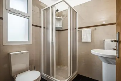a bathroom with a shower and a toilet and a sink at Casas do Salao by Homie in Porto Moniz