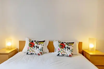 a bedroom with a bed with towels on it at Casa da Praia in Vila Baleira