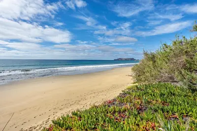 a sandy beach with the ocean in the background at Casa da Praia in Vila Baleira