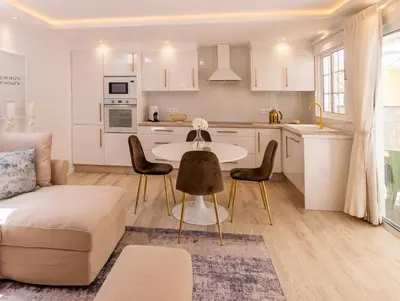 a kitchen and living room with a table and chairs at Little Townsuite Funchal in Funchal