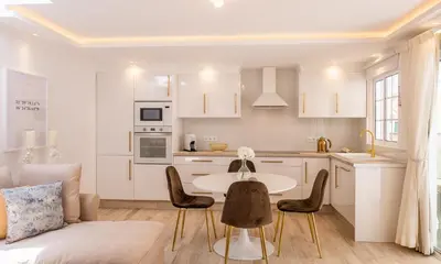 a kitchen and living room with a table and chairs at Little Townsuite Funchal in Funchal