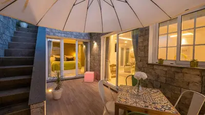 a room with a table and a room with a bed at Little Townsuite Funchal in Funchal