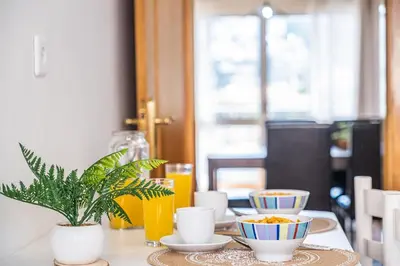 a table with bowls of food and a plant on it at My Place in Funchal by Homie in Funchal