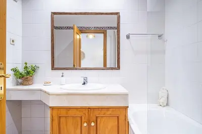 a bathroom with a sink and a tub and a mirror at My Place in Funchal by Homie in Funchal