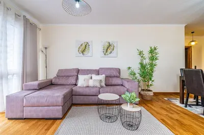 a living room with a purple couch and a table at My Place in Funchal by Homie in Funchal