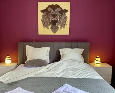 a bedroom with a bed with a lion head on the wall at Villa Paraiso - Traumgarten, Meerblick, Wandern und Golf in Funchal