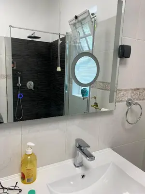 a bathroom with a sink and a mirror at Villa Paraiso - Traumgarten, Meerblick, Wandern und Golf in Funchal