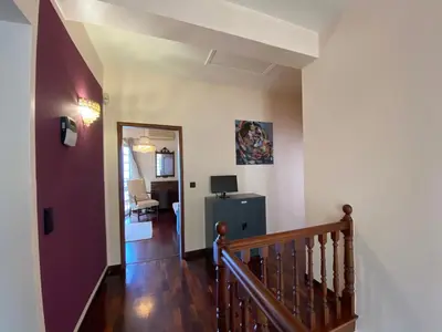 a hallway with a staircase leading to a living room at Villa Paraiso - Traumgarten, Meerblick, Wandern und Golf in Funchal