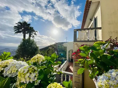 a house with flowers on the side of it at Villa Paraiso - Traumgarten, Meerblick, Wandern und Golf in Funchal
