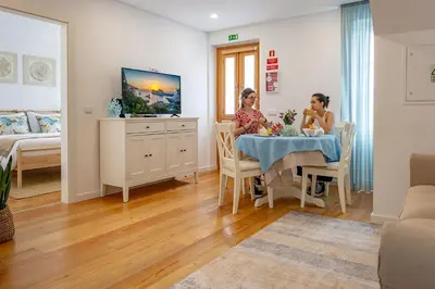 two women sitting at a table in a room at Casa de Sao Tiago 2 in Funchal
