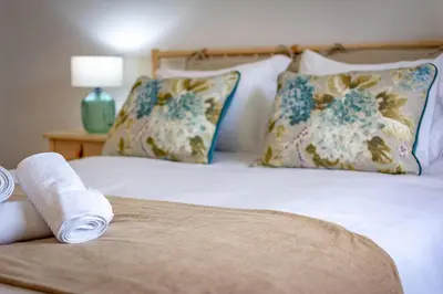 a bed with two pillows and a towel on it at Casa de Sao Tiago 2 in Funchal