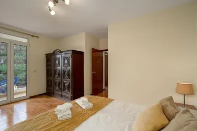 a bedroom with a bed with two towels on it at Vigário House in Câmara de Lobos