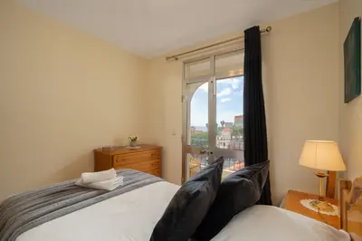 a bedroom with a bed and a window with a view at Vigário House in Câmara de Lobos