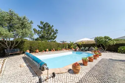 a pool with a water slide in a yard at Bliss Villa in Aljezur