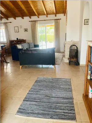 a living room with a couch and a rug at Bliss Villa in Aljezur