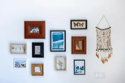 a living room with a blue couch and a large window at Filha do Pisco in Burgau