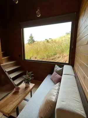 a couch in a room with a large window at Mountain Eco Shelter 3 in Funchal
