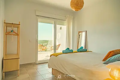 a bedroom with a bed and a window with a view at Wayra Lodge [Kanchay] in Raposeira