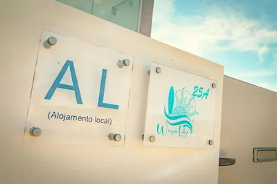 a sign for aaa on the side of a building at Wayra Lodge [Kanchay] in Raposeira