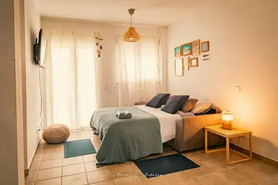 a bedroom with a bed and a large window at Wayra Lodge [Samay] A different sunset every day in Raposeira