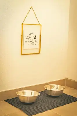 two bowls on a table with a picture on the wall at Wayra Lodge [Samay] A different sunset every day in Raposeira